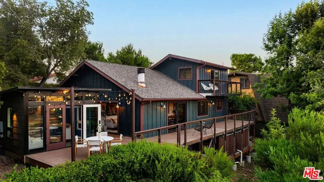 a view of a house with a chairs and table in a patio