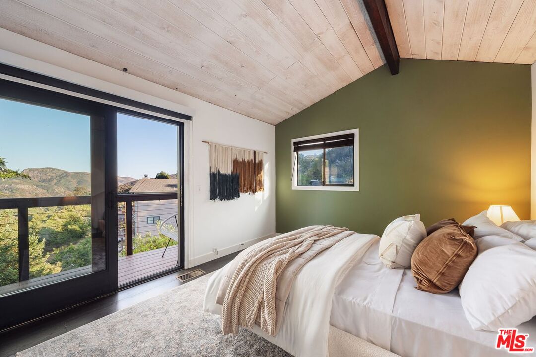 19806 Valley View Drive Topanga, CA 90290 - Photo 36 of 66 a bedroom with a bed and a large window