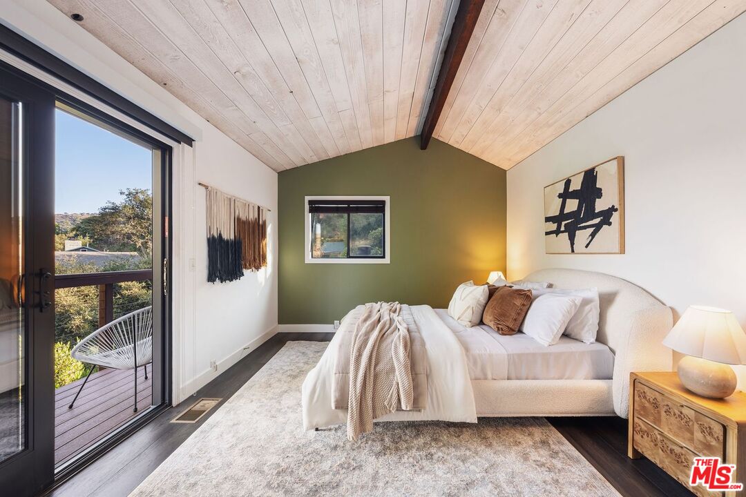 19806 Valley View Drive Topanga, CA 90290 - Photo 37 of 66 a bedroom with a bed and glass door