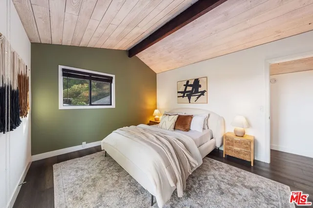 a bedroom with a bed and a dresser