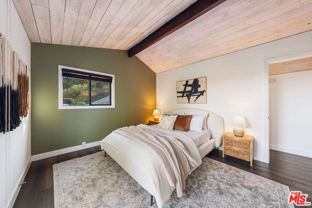 19806 Valley View Drive Topanga, CA 90290 - Photo 38 of 66 a bedroom with a bed and wooden floor