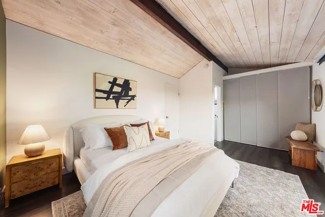 a bedroom with a large bed and a large window