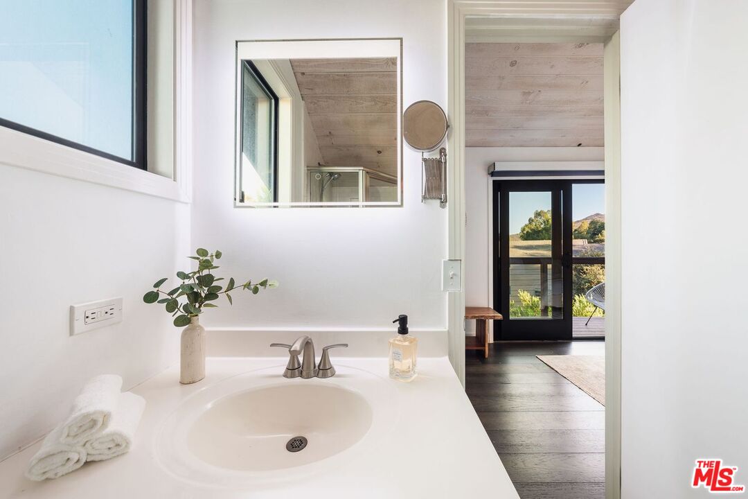 19806 Valley View Drive Topanga, CA 90290 - Photo 40 of 66 a bathroom with a sink and a mirror