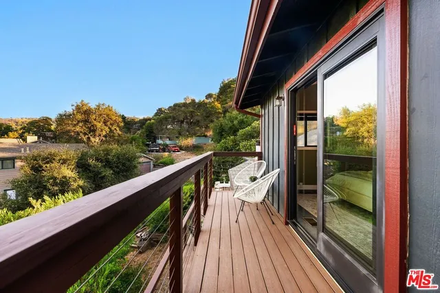 an aerial view of a house with a yard and lake view