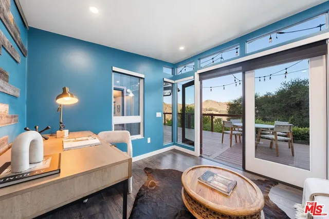 a view of a balcony with furniture and wooden floor