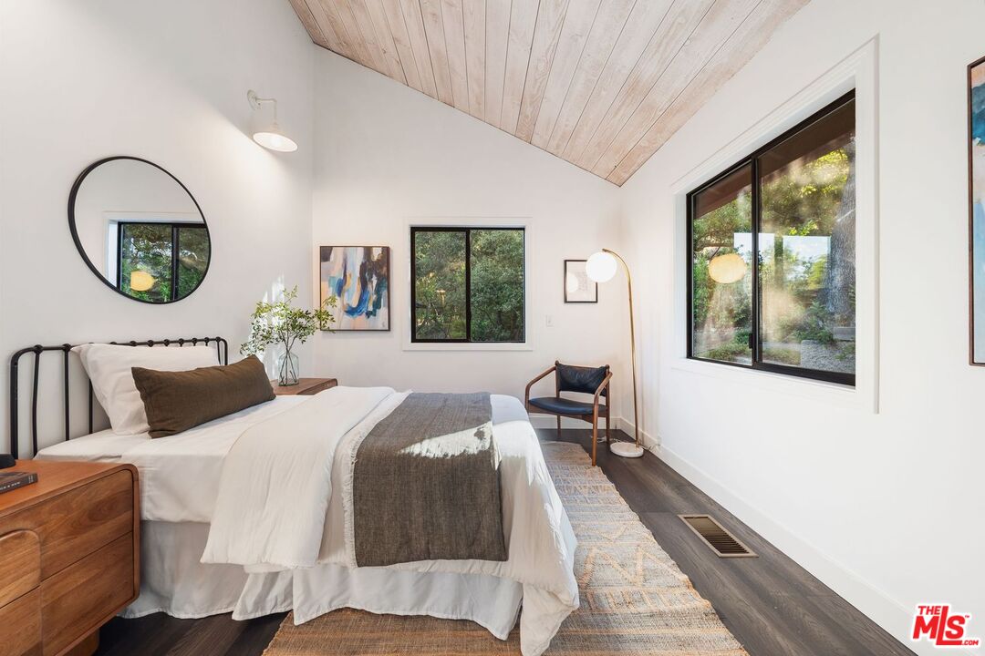 19806 Valley View Drive Topanga, CA 90290 - Photo 54 of 66 a bedroom with a large bed and a large window