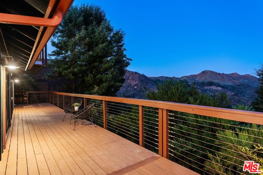 19806 Valley View Drive Topanga, CA 90290 - Photo 65 of 66 a view of balcony with wooden floor and trees in the background