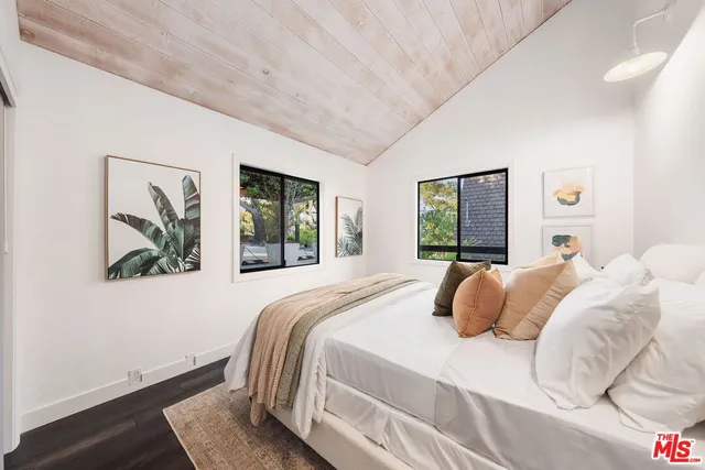 a bedroom with a large bed and a window