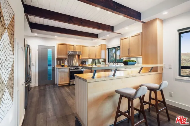 a kitchen with stainless steel appliances a stove sink and cabinets