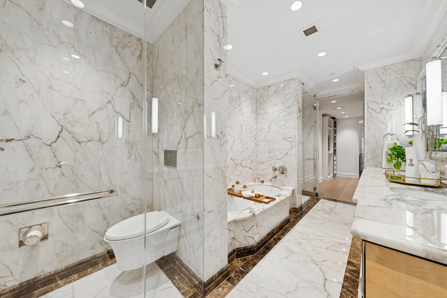 27 East 79th Street, Unit DUPLEX7/8 Manhattan, NY 10075 - Photo 11 of 20 a bathroom with a granite countertop sink a toilet and shower