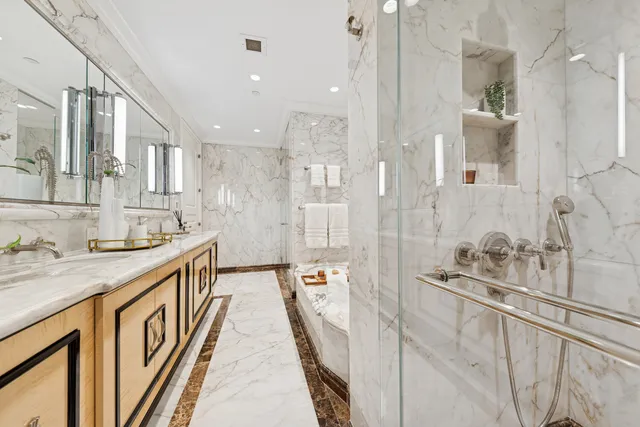a bathroom with a granite countertop sink a toilet and shower