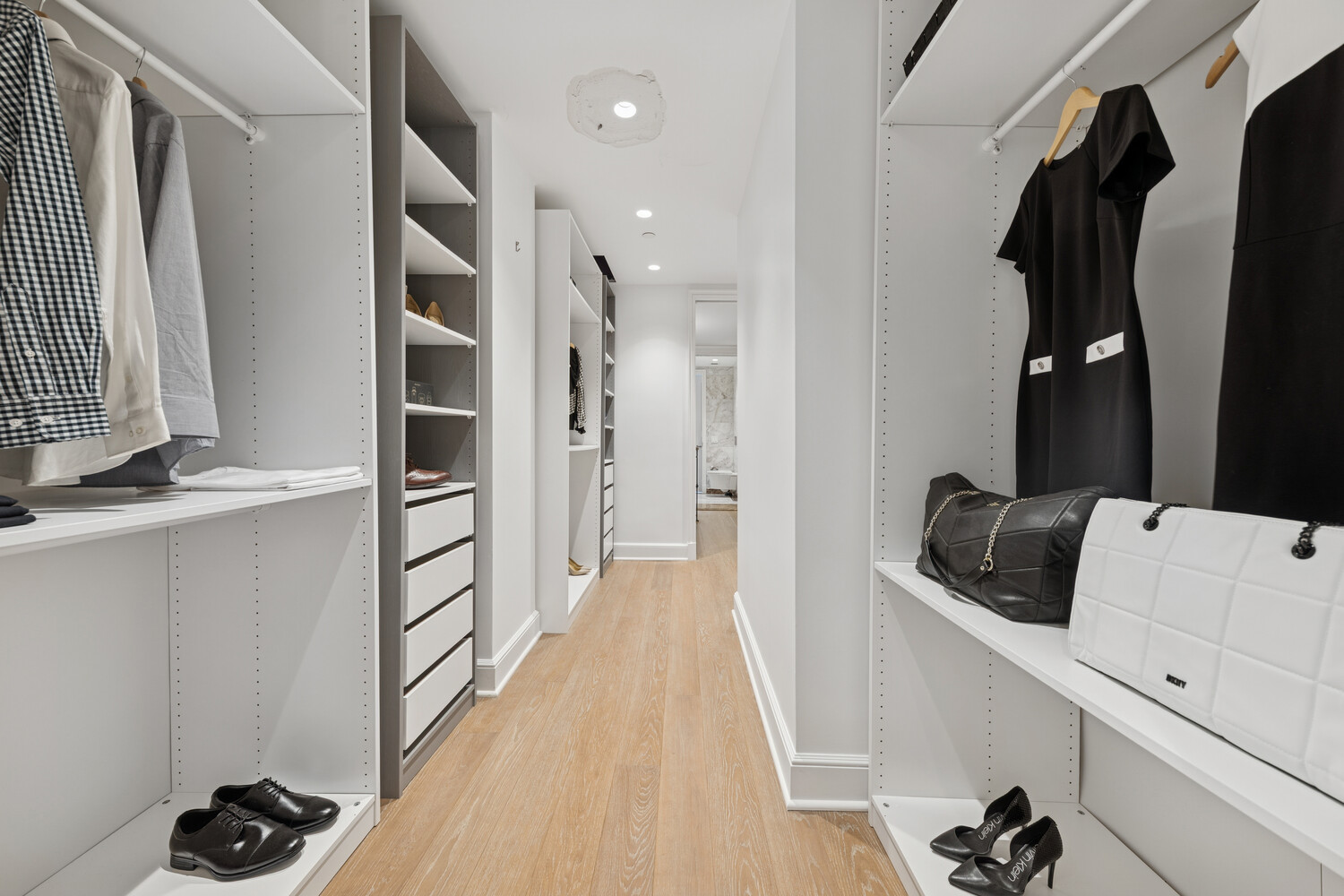 27 East 79th Street, Unit DUPLEX7/8 Manhattan, NY 10075 - Photo 13 of 20 a view of walk in closet with clothes and shoes