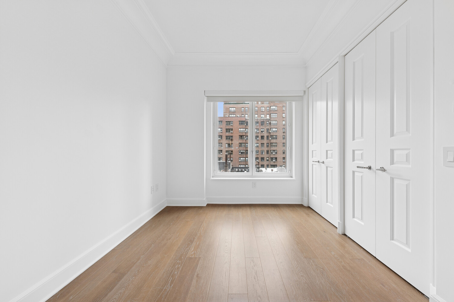 27 East 79th Street, Unit DUPLEX7/8 Manhattan, NY 10075 - Photo 15 of 20 an empty room with wooden floor and windows