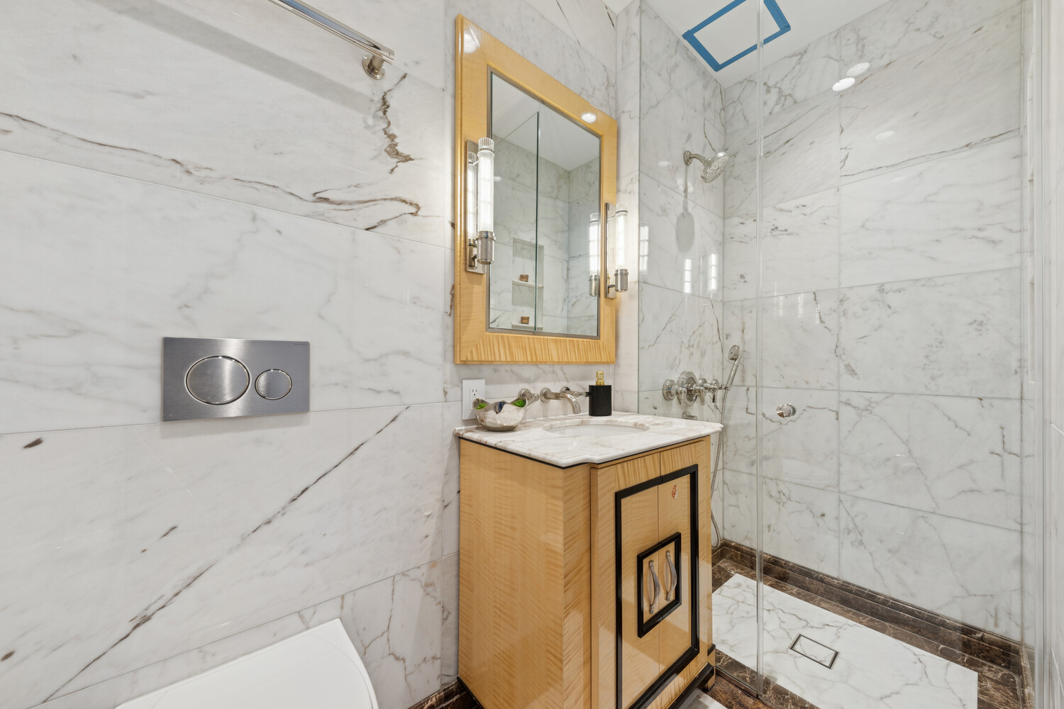 27 East 79th Street, Unit DUPLEX7/8 Manhattan, NY 10075 - Photo 18 of 20 a bathroom with a sink a toilet and shower