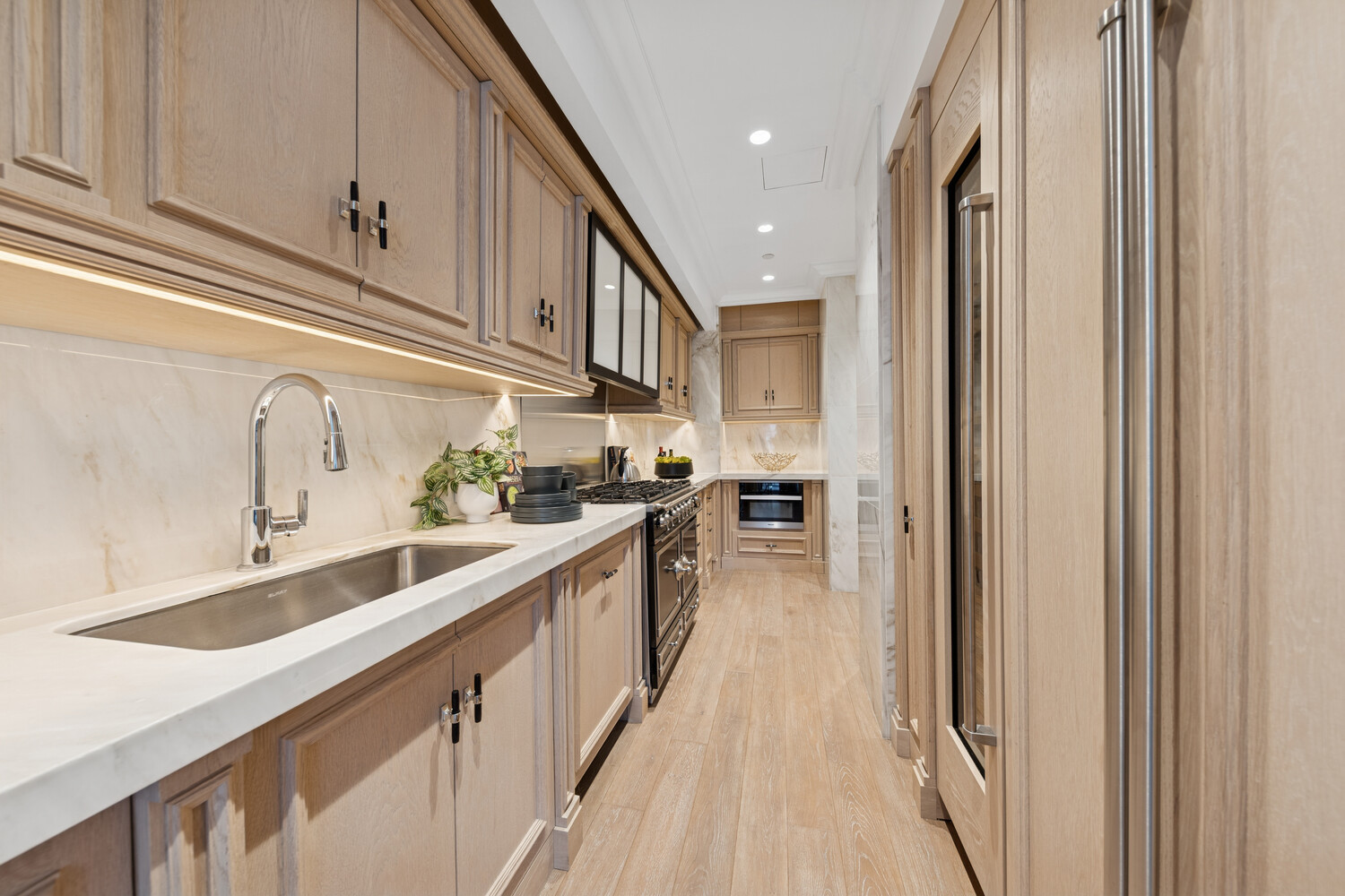 27 East 79th Street, Unit DUPLEX7/8 Manhattan, NY 10075 - Photo 4 of 20 a kitchen with stainless steel appliances granite countertop lots of counter top space and wooden floor