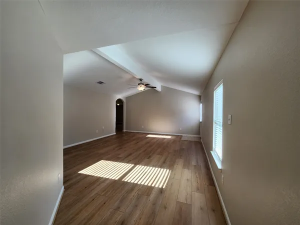 wooden floor in a hall with an empty room