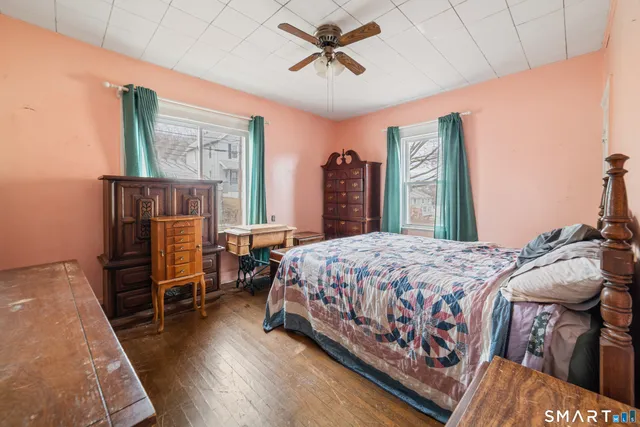 an empty room with wooden floor and a window