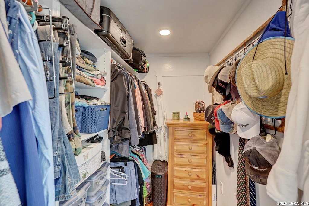 283 2nd Street Harper, TX 78631 - Photo 14 of 46 a view of walk in closet with clothes and shoes