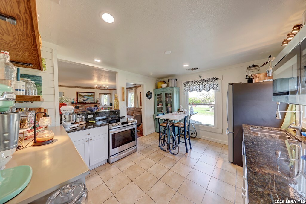283 2nd Street Harper, TX 78631 - Photo 17 of 46 a kitchen with granite countertop a sink and appliances