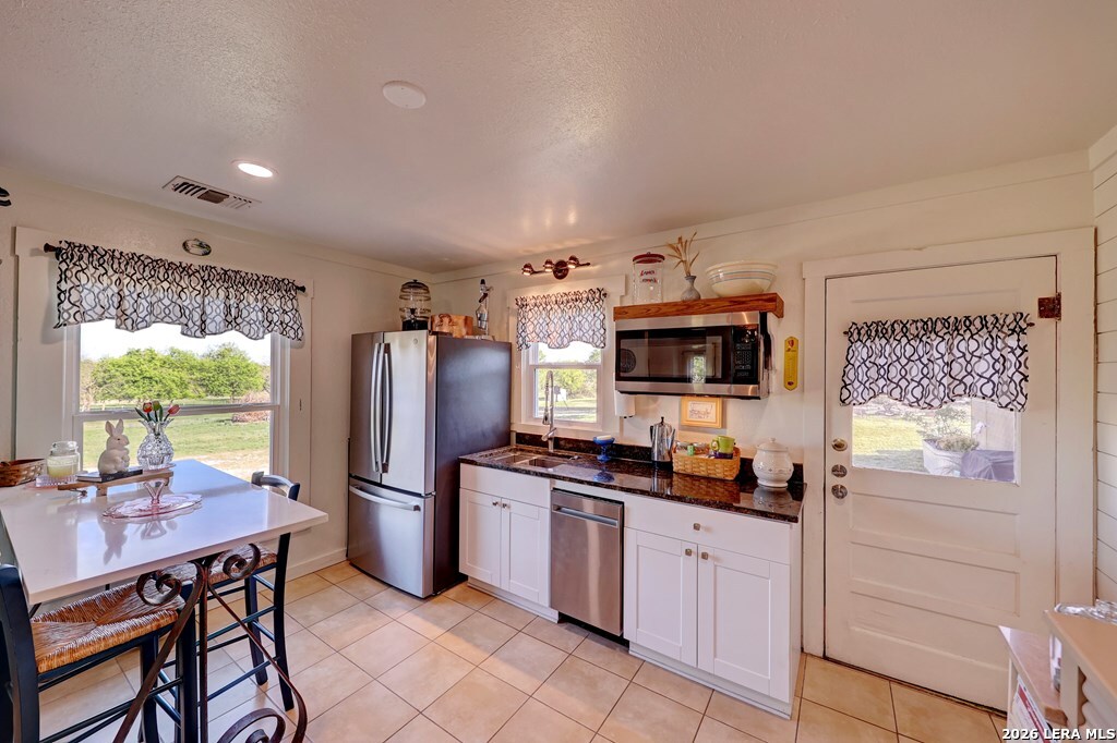 283 2nd Street Harper, TX 78631 - Photo 18 of 46 a kitchen with stainless steel appliances a refrigerator and stove