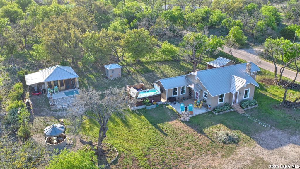 283 2nd Street Harper, TX 78631 - Photo 2 of 46 an aerial view of a house with swimming pool and a yard
