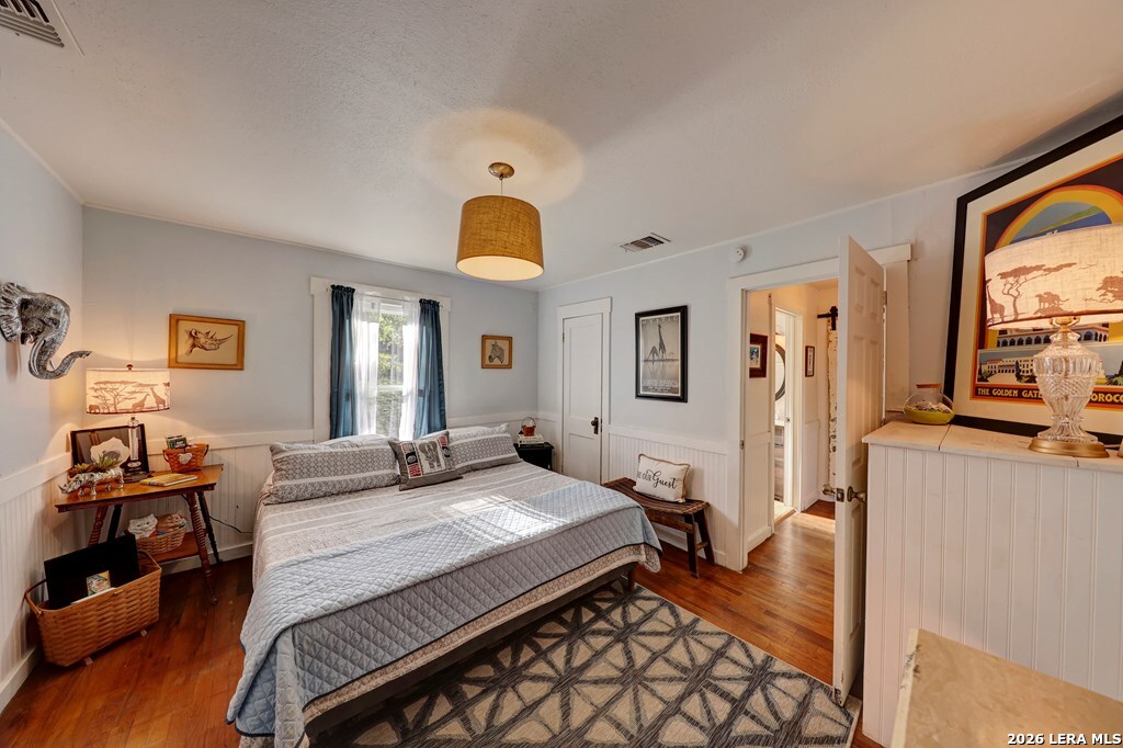 283 2nd Street Harper, TX 78631 - Photo 22 of 46 a bedroom with a bed and wooden floor