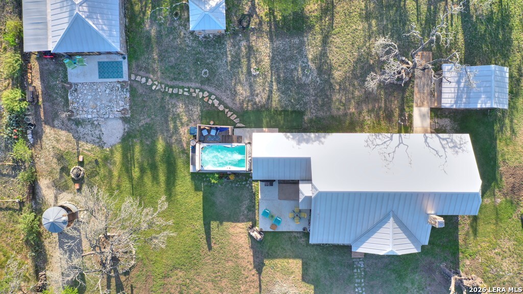 283 2nd Street Harper, TX 78631 - Photo 40 of 46 a aerial view of a house with swimming pool and large trees