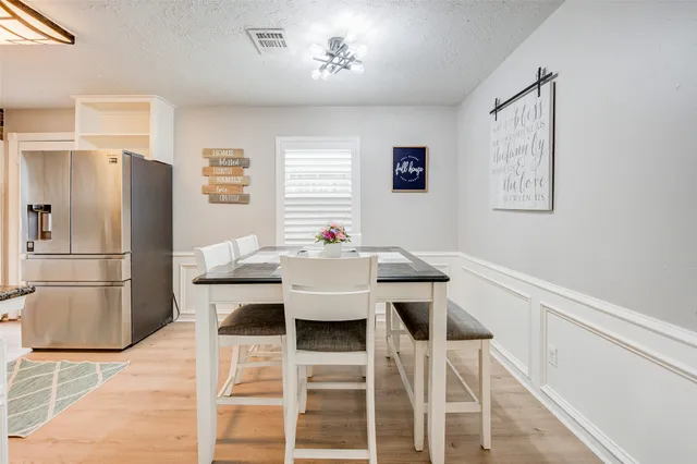 a view of a dining room with furniture and a kitchen
