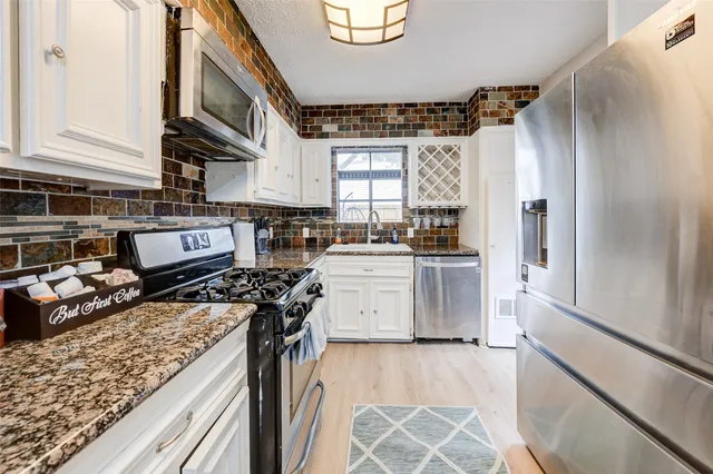 a kitchen with a stove and a refrigerator