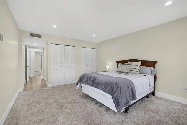 a spacious bedroom with a bed and a walk in closet