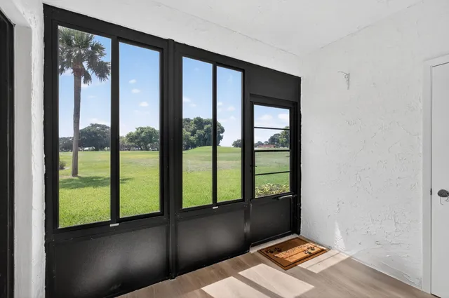 an empty room with floor to ceiling windows
