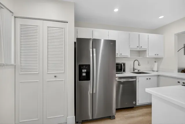 a kitchen with cabinets and stainless steel appliances