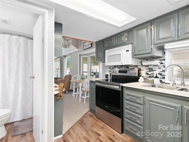 a kitchen with a sink cabinets and stainless steel appliances