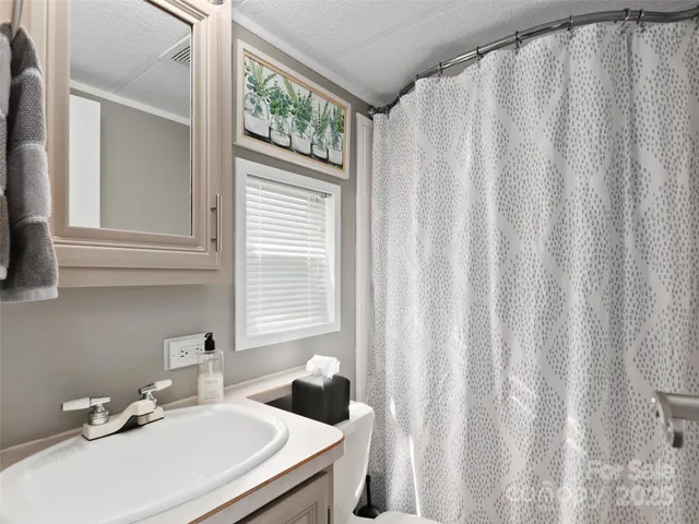 a bathroom with a sink a mirror and a window