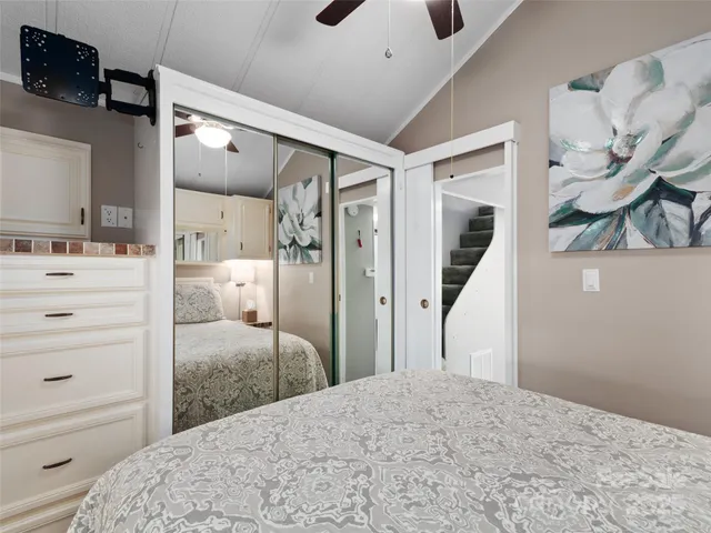 a bedroom with a bed and a mirror