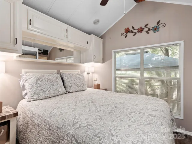 a bedroom with a large bed and a large window