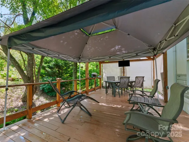 a view of a patio with table and chairs under an umbrella