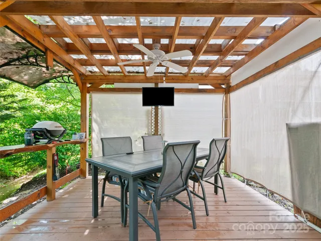 a view of a patio with table and chairs and potted plants
