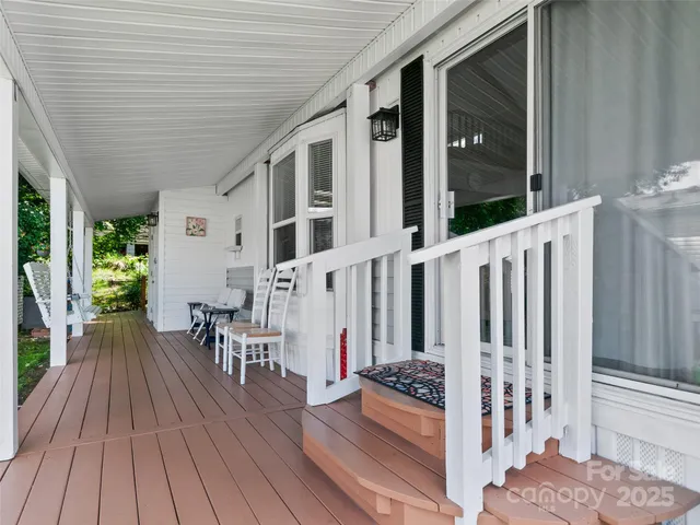 a view of a patio with table and chairs with wooden floor