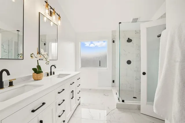 a bathroom with a shower sink and mirror
