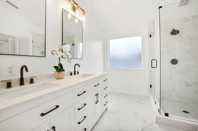 a bathroom with a shower sink and mirror