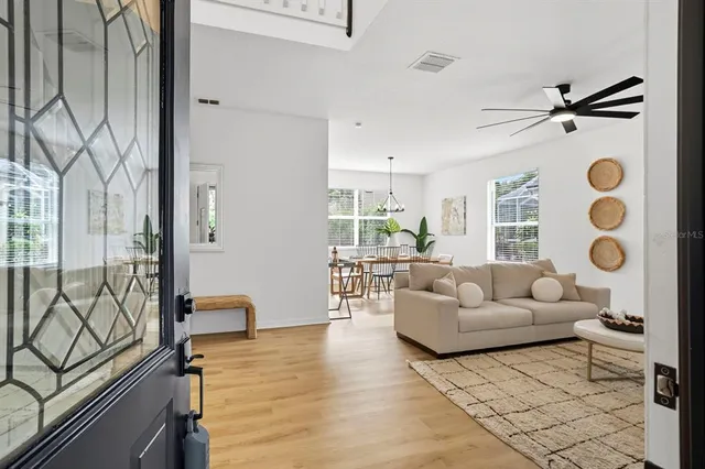 a living room with furniture and wooden floor