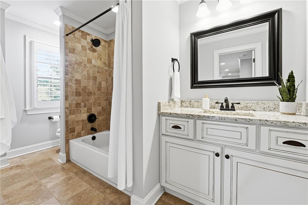 18 Starlight Drive Cartersville, GA 30121 - Photo 30 of 74 a bathroom with a granite countertop sink mirror and a bathtub