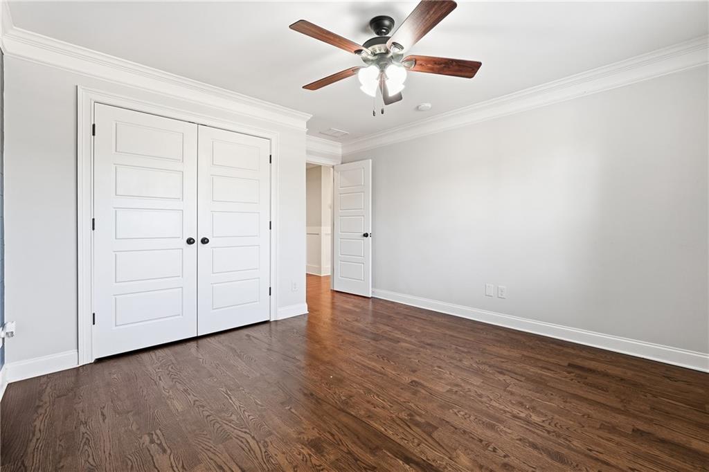 18 Starlight Drive Cartersville, GA 30121 - Photo 34 of 74 an empty room with wooden floor chandelier fan and windows