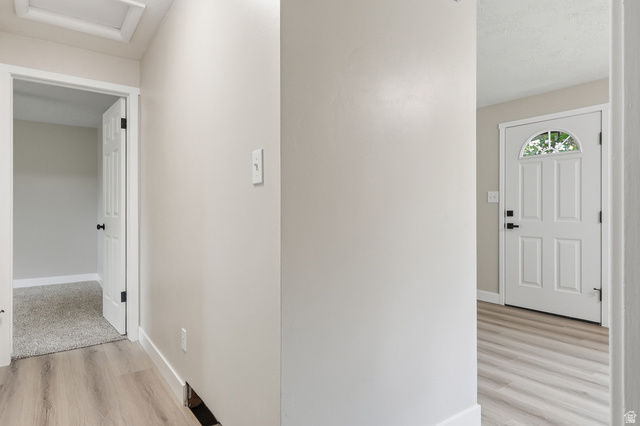 629 King Circle Layton, UT 84041 - Photo 12 of 26 Entryway featuring wood-finish flooring, a six-panel door with a half-moon glass insert, and light neutral wall tones