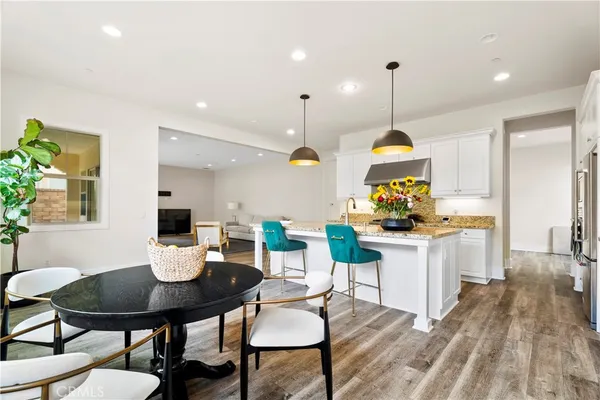 a kitchen with a dining table chairs and kitchen view