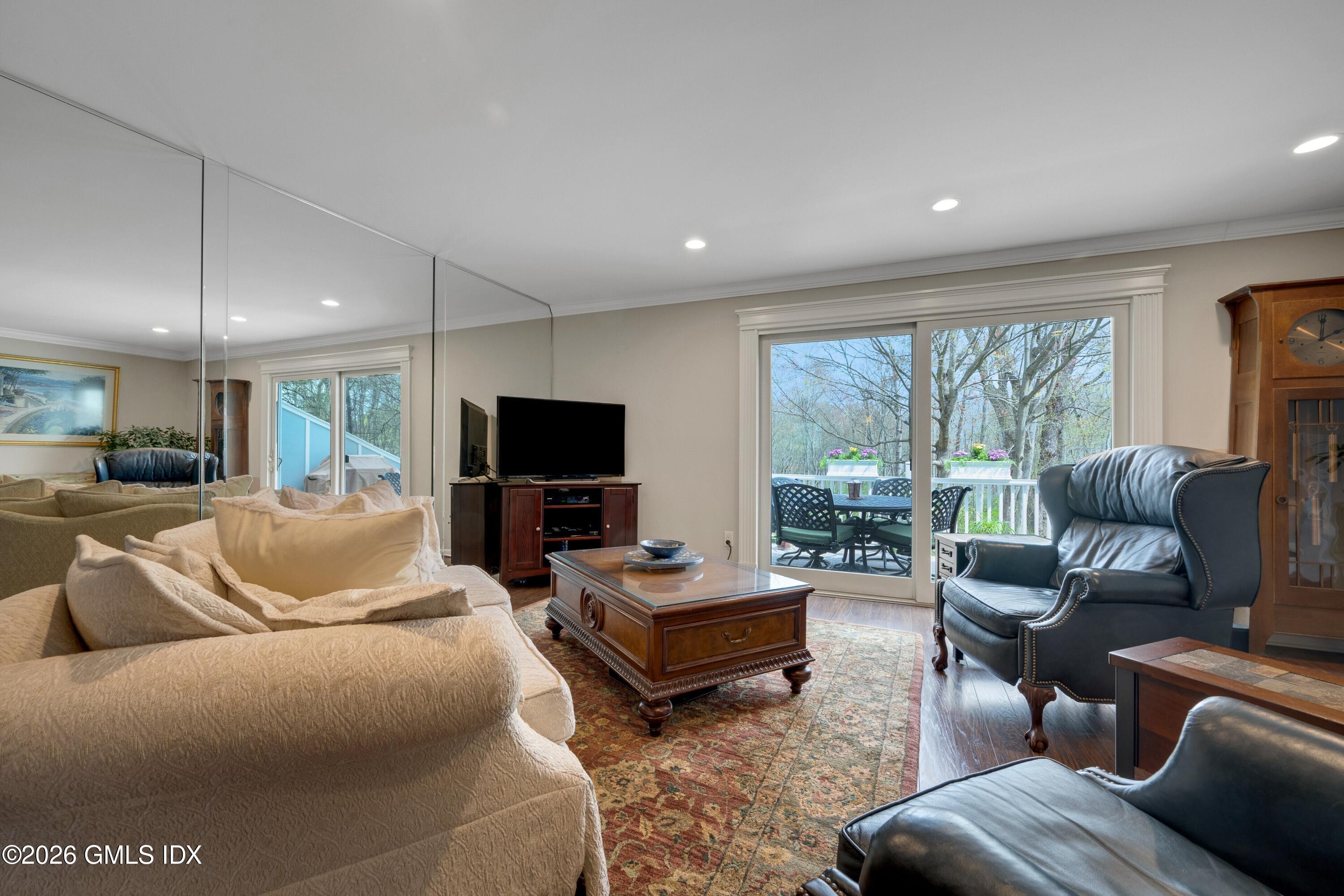 58 Stirrup Lane, Unit 58 Riverside, CT 06878 - Photo 6 of 23 a living room with furniture and a flat screen tv