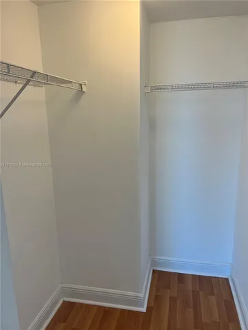 a living room with furniture and a kitchen view