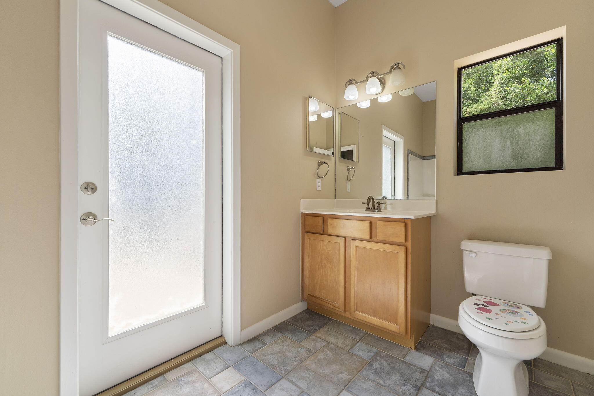 12 Hillcrest Drive Shalimar, FL 32579 - Photo 17 of 45 a bathroom with a toilet sink and mirror