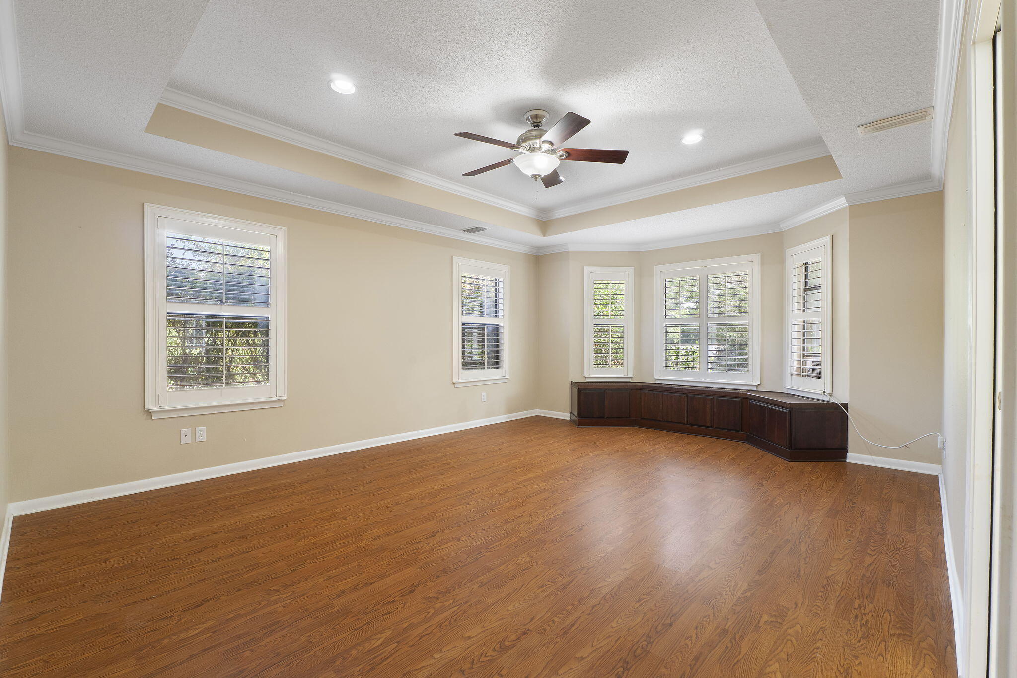 12 Hillcrest Drive Shalimar, FL 32579 - Photo 19 of 45 a view of an empty room with a window and wooden floor